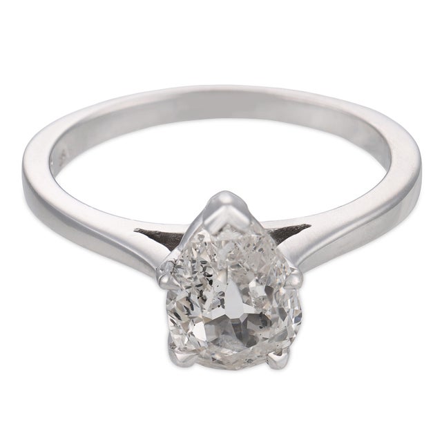 This elegant vintage diamond engagement ring is a timeless 1990’s design, centered by a GIA-certified antique pear cut...