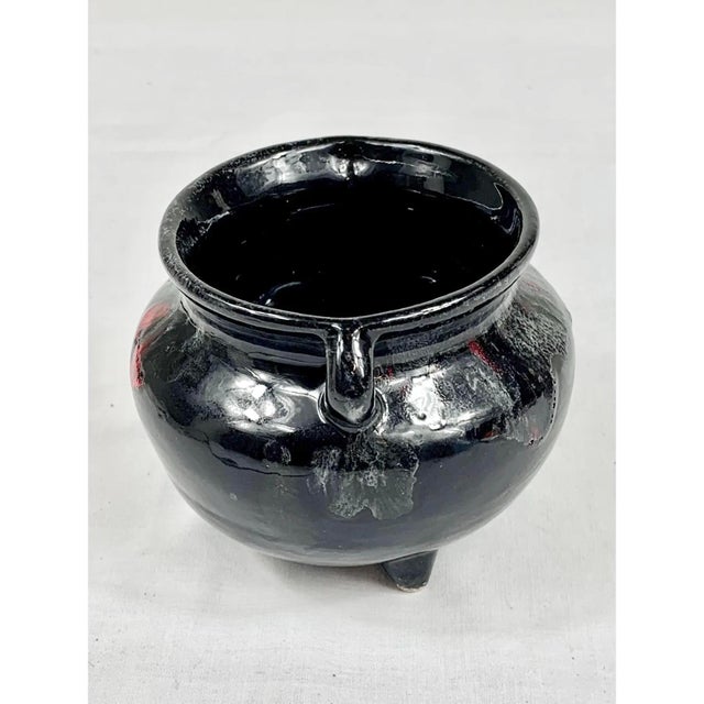 Add a touch of vintage character to your space with this striking 1980s Cherokee pottery cauldron bowl. Crafted with a...