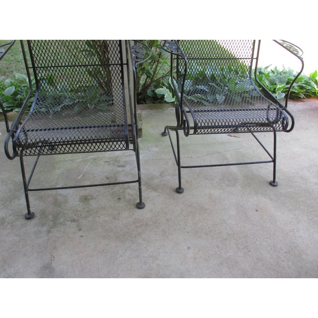 This is a Awesome! pair of Vintage Attributed to Woodard wrought iron arm lounge chairs—ideal for injecting some mid-...