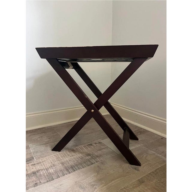 Dark mahogany finish wood butler tray table features a removable serving tray with a distinctive woven bamboo or rattan...
