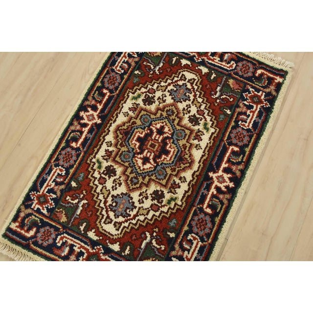 A traditional tribal Heriz rug hand-knotted with fine wool on a cotton foundation. This oriental rug features a central...
