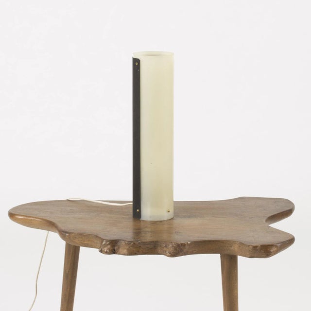 Cool table lamp from ASEA, in a cylinder shape made from plastic and a lacquered metal sheet enveloping half of the lamp....