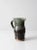 This is a vintage studio pottery pitcher in hand-thrown ceramic with a rich brown and green glaze. organic form with...