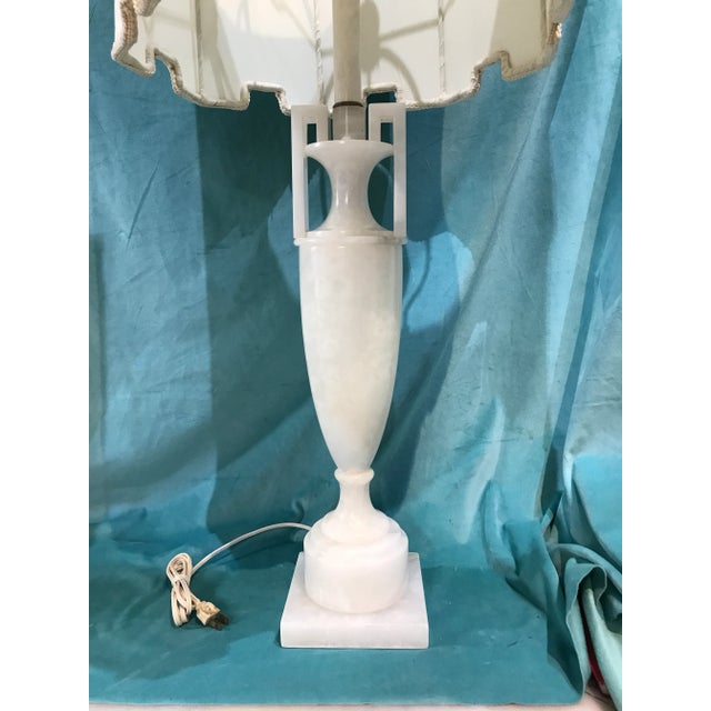 Alabaster lamp in the shape of an amphora or urn with original say as phone in a Palm Beach home estate sale The white...