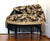I personally love this chair with its cherub upholstered tweed-like fabric covered with little putti and the dark walnut...