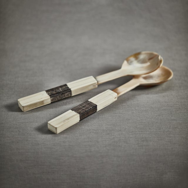 Beautifully crafted horn salad servers, each utensil features a simple shape with a finish that accentuates the horn's...