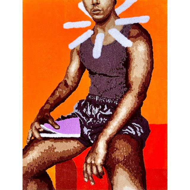 A figure sits against a field of burning orange and red, a burst of white rays radiating behind the head, part halo, part...