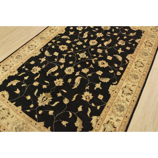 A traditional Ziegler rug hand-knotted with fine wool on a cotton foundation. This rug features a botanical design set...