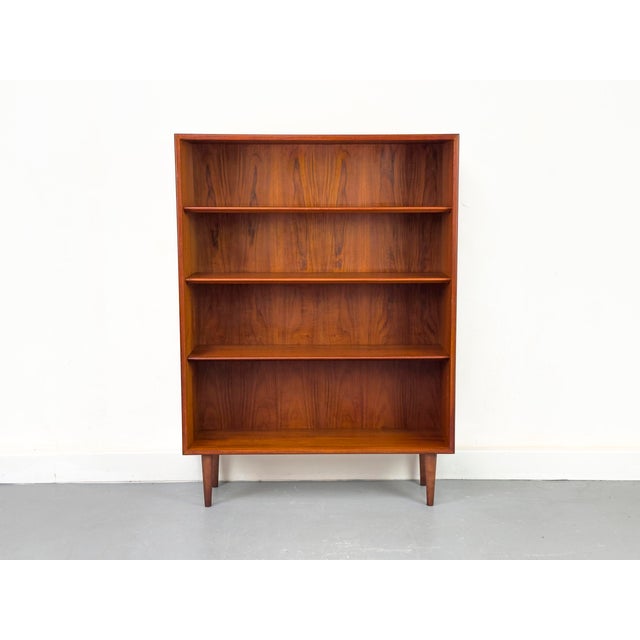 Teak bookcase designed by B. Mogensen for Søborg Møbelfabrik. Inside, there are three adjustable shelves with beveled...