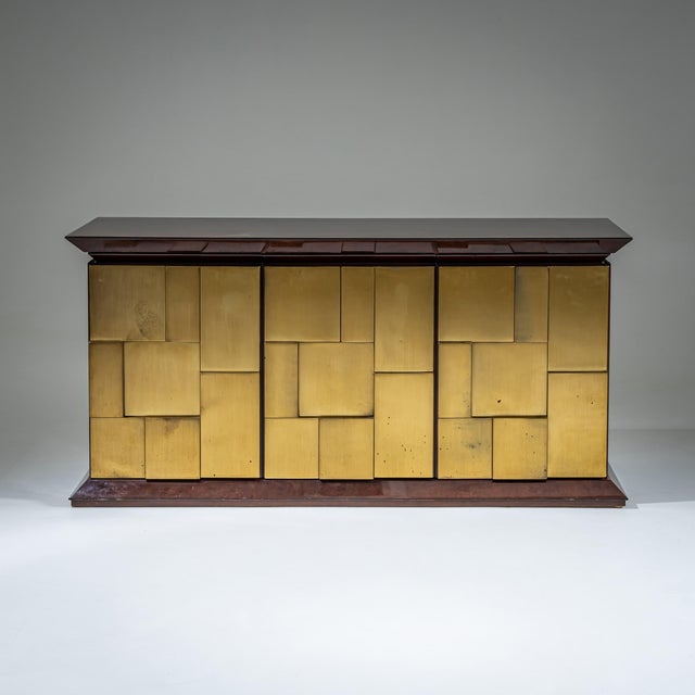 Three-door sideboard by Luciano Frigerio with a brass front composed of irregular rectangular panels, partly executed in...