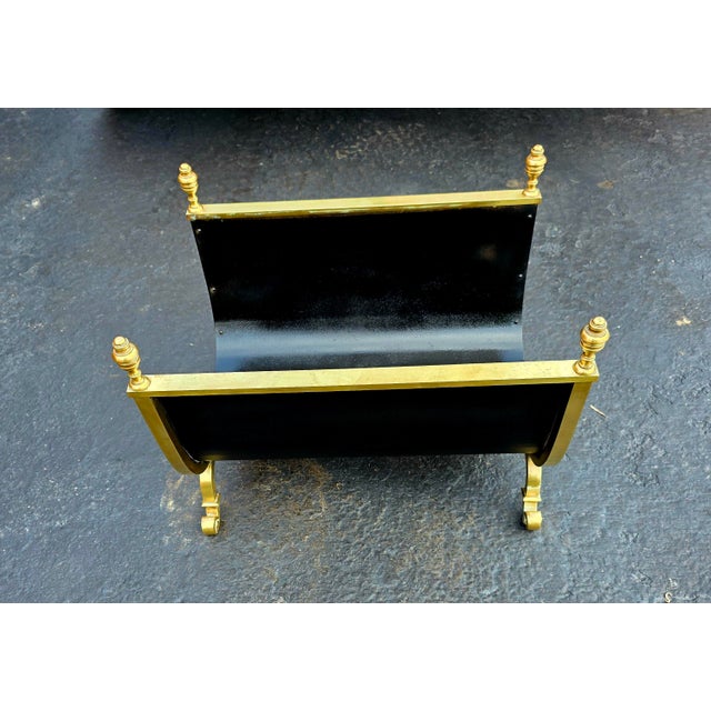 Antique brass and iron log holder in the shape of a U and framed in brass with interesting embellishments such as round...