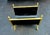 Antique brass and iron log holder in the shape of a U and framed in brass with interesting embellishments such as round...