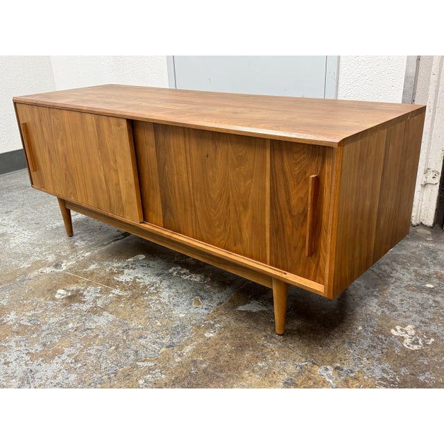 Design Plus Gallery presents a Grove Walnut Media Cabinet from Room & Board. This walnut cabinet has a streamlined profile...