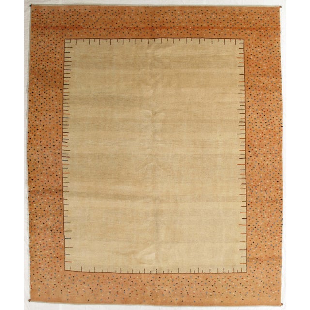 Vintage hand-knotted Persian Gabbeh rug featuring a soft, open field framed by a decorative border with fine geometric...