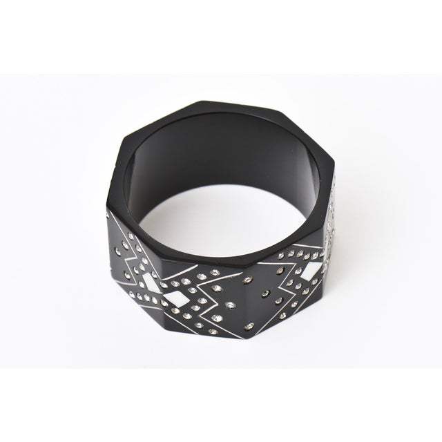 This chic vintage French black resin bangle cuff bracelet has rhinestone designs of the influence of the art deco style....