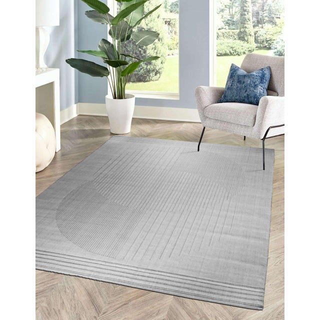 A hand-knotted wool rug, made in India and measuring 4' x 6'. Geometric drawing - repeating motifs held inside strong...