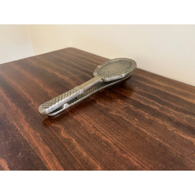 A wonderfully distinctive vintage door knocker cast in the form of a traditional tennis racket. The oval head features a...