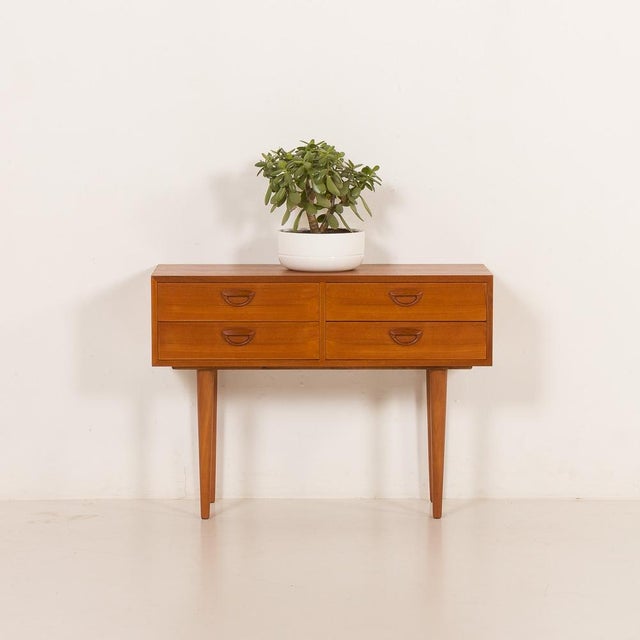 Meticulously crafted in teak, this low dresser designed by kai kristiansen was manufactured by feldballe møbelfabrik in...