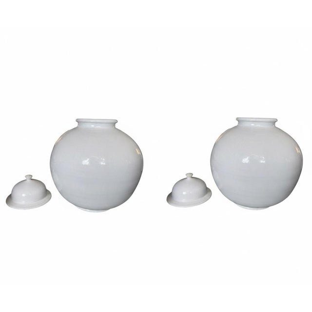 The manufacturer is unknown. This sophisticated pair of white ginger jars offers a timeless, clean aesthetic that fits...