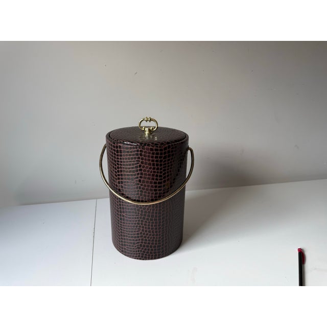 Vintage 1980s faux brown crocodile large regency style lidded ice bucket with gold tone metal accents.