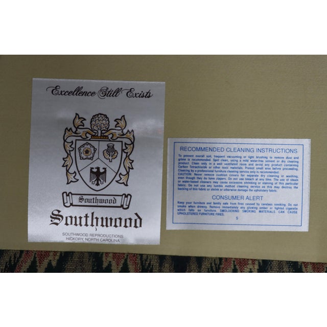 Classic settee upholstered in a flame stitch pattern in soft blues and muted reds. Features rolled arms, a comfortable...