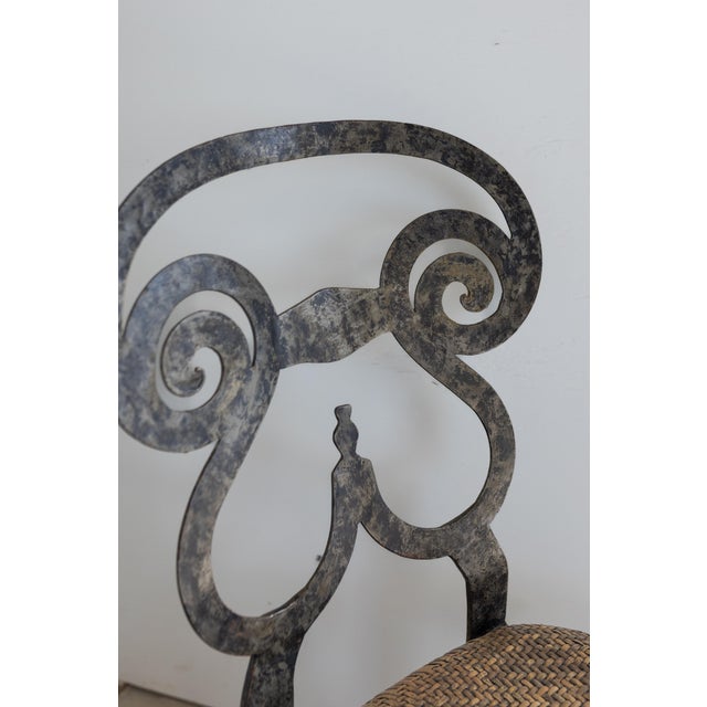 A striking blend of sculptural form and artisanal craftsmanship, this Biedermeier-style forged iron dining or side chair...