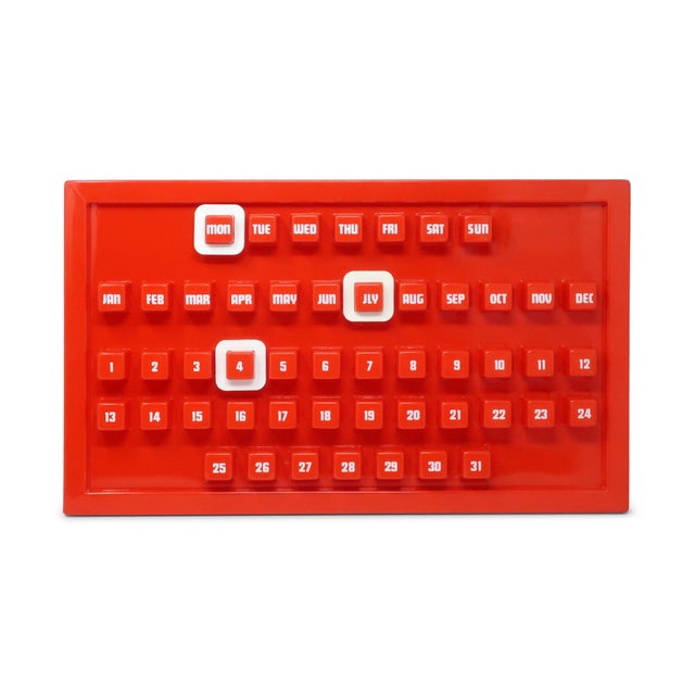 A fantastic example of 1970s mod design, this bright red plastic perpetual wall calendar delivers bold graphic impact....
