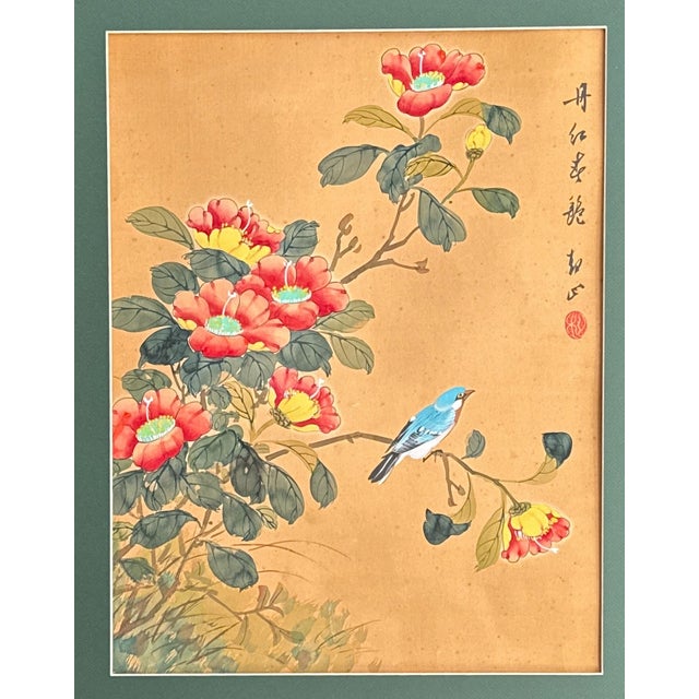 This vibrant Asian painting features a blue bird perched on a branch and surrounded by red, pink and yellow flowers and...
