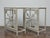 A pair of 19th-century French consoles combining a painted iron frame with inset carved wood panels, all unified under a...