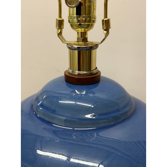 Classic blue table lamp by Ralph Lauren. Slight crackle finish beneath the glaze gives a luminous quality. Wood base with...