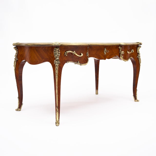 An exceptional French Louis XV style bureau plat, dating to the late 19th or early 20th century and in the manner of...