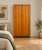 A stylish 1960s teak wardrobe with two doors, rounded frame detailing and tapered legs. Internally fitted with a hanging...