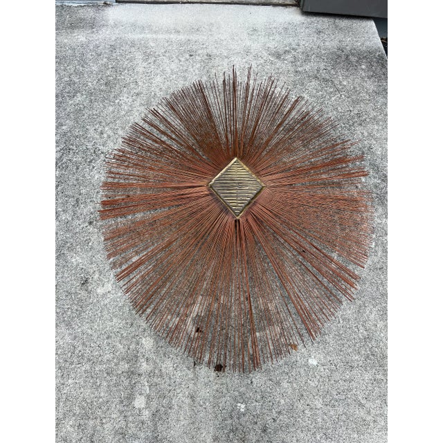 An authentic 1960s Brutalist sunburst wall sculpture designed by brothers William and Bruce Friedle. This highly...