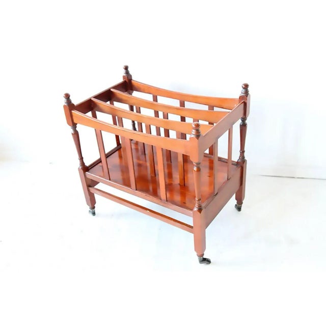 Elegant midcentury magazine holder on castors, very good condition. Size: Height 25'' Length 20.5'' Depth 13.5''.