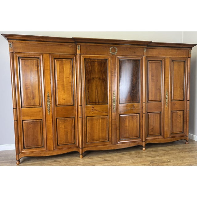 A magnificent Vintage 6 Door Ehalt wardrobe, beautifully crafted with elegant panelled doors, warm rich finish, and...