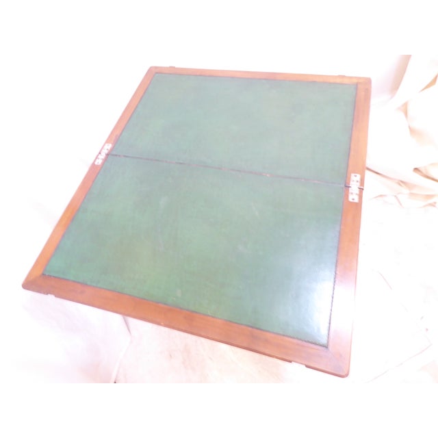 This leather top coaching table can be folded up and measures 28"H x 34"W x 30.25"D and makes a nice desk or small game...