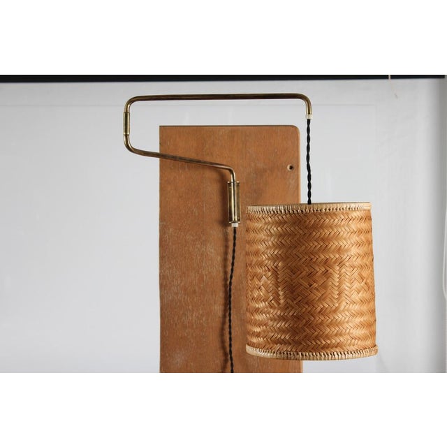 Vintage flexible wall lamp in the style of Finish designer Paavo Tynell, made in Denmark in the 1950s The wall light has a...