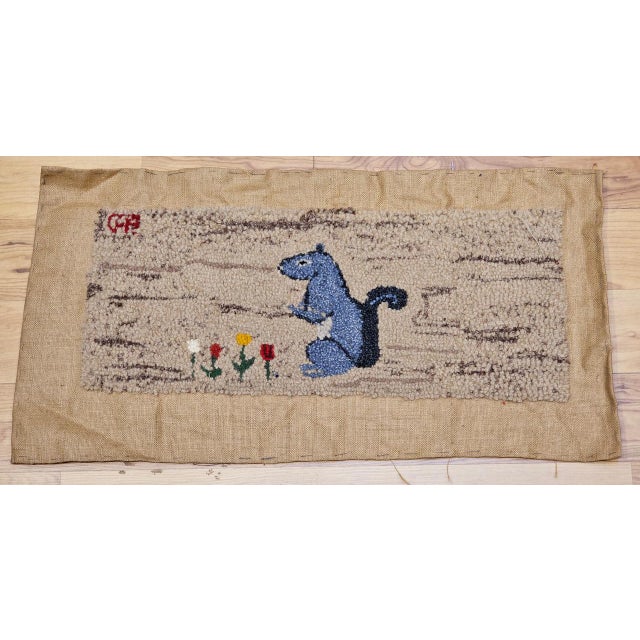 A vintage American hand-hooked rug of delightful originality and wit � a standing squirrel depicted with charming...
