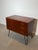 A stylish mid-century modern chest of drawers by G-Plan, crafted in richly figured teak and elevated on elegant black...