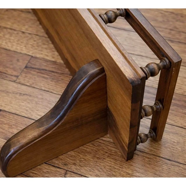 Solid wood gallery rail shelf with turned spindle detail, designed with a generous ledge and sculptural supports. Warm,...