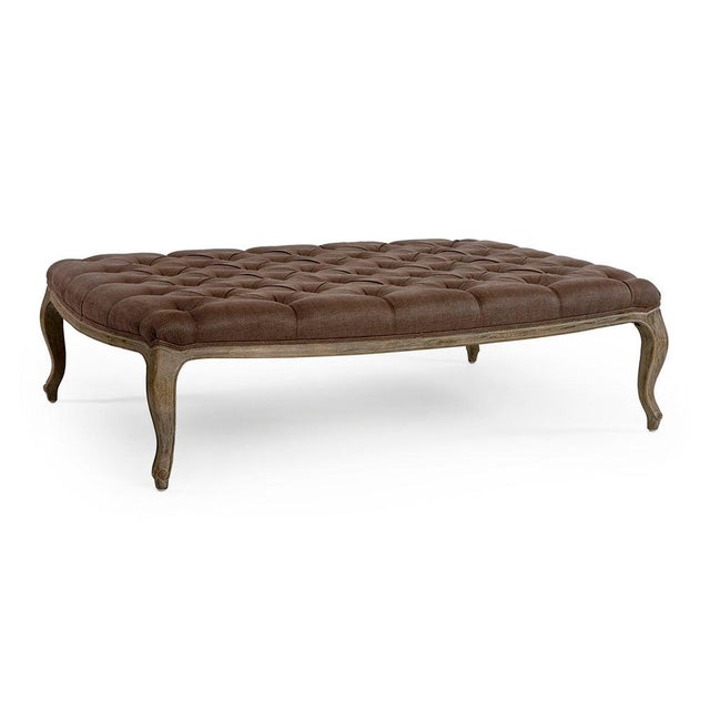 The Maison Tufted Rectangular Ottoman from Zentique features rich copper-brown linen with deep button tufting on a...