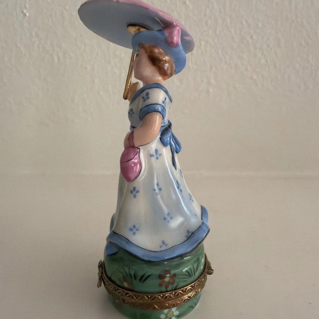 Now retired limited edition (#17 of 500) Limoges trinket box hand painted by SD, which features a woman dressed in blue...