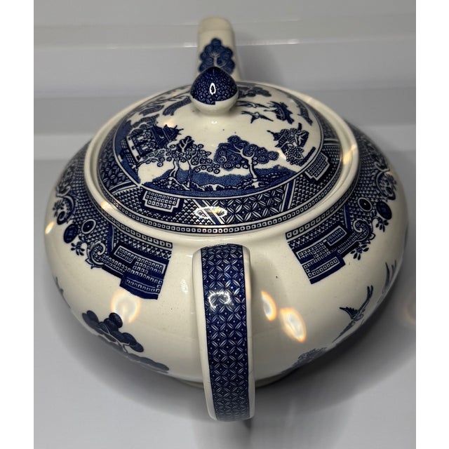 A timeless English Blue Willow teapot featuring the iconic cobalt chinoiserie pattern in a classic mid-century form....