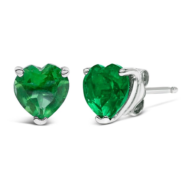 Discover the quintessence of elegance with these heart-shaped green emerald stud earrings, exquisitely cradled in 14K...