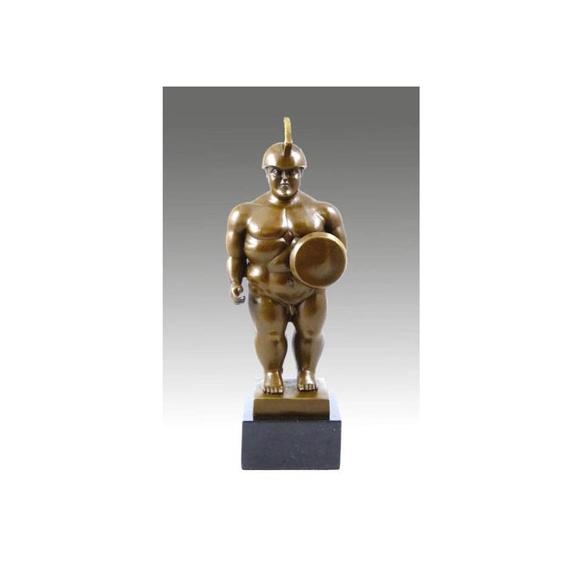 This solid bronze sculpture depicts a standing Roman warrior, equipped with a helmet, a shield, and a sword. The work...