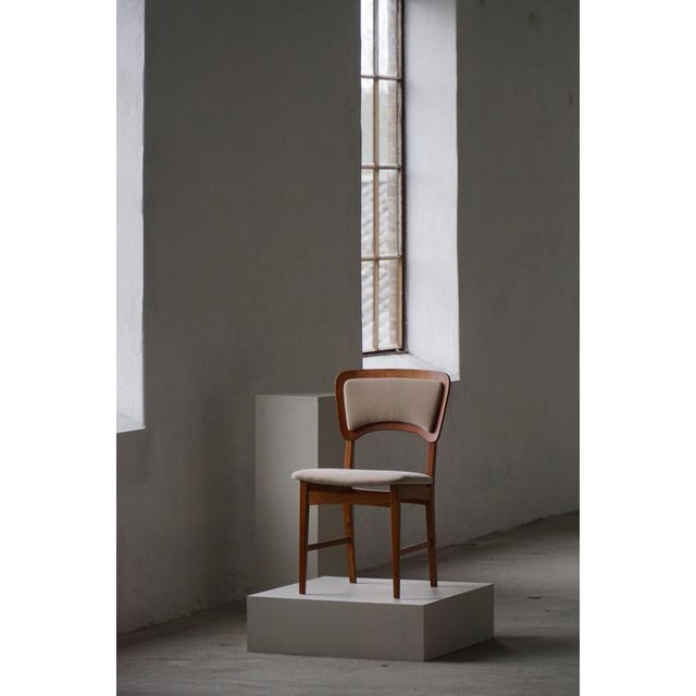 A refined set of six Danish dining chairs, showcasing the elegance and craftsmanship of mid-century Scandinavian design....