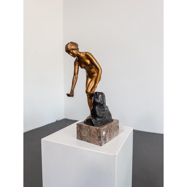 A finely detailed bronze sculpture by Austrian artist Robert Rudolfi (1873–1935), titled An der Quelle (“At the Spring”)....