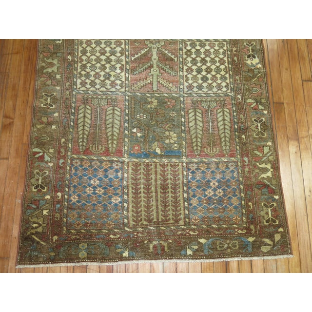 An antique Persian Bakhtiari rug with all-over garden box niche motif in earth tones 4'1'' x 6'4''