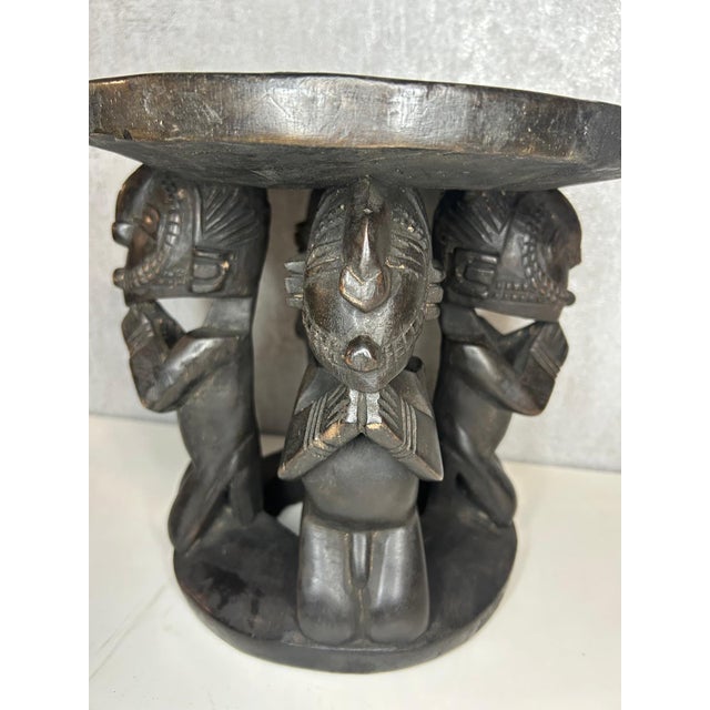 Originating from the traditional Baga art of Guinea, this carved wooden stool is a remarkable piece where utilitarian...