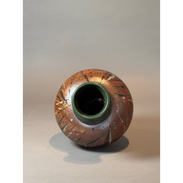 This signed handcrafted stoneware vase is a stunning example of artisan ceramic craftsmanship, featuring an organic,...